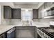 Updated kitchen with stainless steel appliances, granite countertops, and stylish gray cabinets at 563 Trillum Sw Ct # 563, Marietta, GA 30008