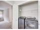 Convenient laundry room featuring a modern washer and dryer set, and wire shelving for organized storage solutions at 563 Trillum Sw Ct # 563, Marietta, GA 30008