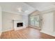 Bright living room featuring stylish laminate wood flooring and a white-painted brick fireplace at 563 Trillum Sw Ct # 563, Marietta, GA 30008