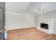 Bright living room featuring stylish laminate wood flooring and a white-painted brick fireplace at 563 Trillum Sw Ct # 563, Marietta, GA 30008