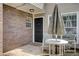 Cozy fenced patio with table and chairs, featuring a dark front door and brick exterior at 563 Trillum Sw Ct # 563, Marietta, GA 30008