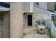Enclosed patio area with table and chairs and black front door in a charming brick townhome at 563 Trillum Sw Ct # 563, Marietta, GA 30008