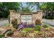 Stone signage with vibrant landscaping welcomes residents to the Woodchase and Coral Ridge private home communities at 563 Trillum Sw Ct # 563, Marietta, GA 30008