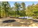 Picturesque backyard featuring a tranquil lake with lush foliage at 8316 Hewlett Rd, Sandy Springs, GA 30350