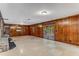 Finished basement with wood paneling, tile floor and a walkout to the backyard at 8316 Hewlett Rd, Sandy Springs, GA 30350