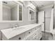 Bathroom featuring marble countertops, double sinks, and a large mirror with decorative lighting fixtures at 8316 Hewlett Rd, Sandy Springs, GA 30350