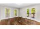 Bedroom with hardwood floors, natural light, two windows, and a set of glass doors to the outside at 8316 Hewlett Rd, Sandy Springs, GA 30350