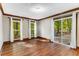 Bright room with hardwood floors, large windows, and sliding glass door with outdoor views at 8316 Hewlett Rd, Sandy Springs, GA 30350