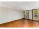 Well-lit room featuring hardwood floors and a view of the lush surroundings at 8316 Hewlett Rd, Sandy Springs, GA 30350