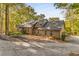 Attractive single-story home featuring a stone foundation and mature trees at 8316 Hewlett Rd, Sandy Springs, GA 30350