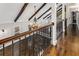 Foyer featuring hardwood floors, exposed beams, a chandelier, and ornate iron railings at 8316 Hewlett Rd, Sandy Springs, GA 30350