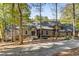 Charming exterior showcasing a quaint home with a stone accents, mature trees, and inviting entrance at 8316 Hewlett Rd, Sandy Springs, GA 30350