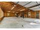 Spacious unfinished garage with high ceilings, ample lighting, and raw wood construction at 8316 Hewlett Rd, Sandy Springs, GA 30350