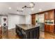 Kitchen island with dark wood cabinets, stainless steel appliances, and hardwood flooring at 8316 Hewlett Rd, Sandy Springs, GA 30350