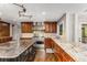 Gourmet kitchen with stainless steel appliances, granite countertops, and custom cabinetry at 8316 Hewlett Rd, Sandy Springs, GA 30350