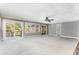 Large carpeted living area with a ceiling fan, sliding glass doors to the deck, and neutral paint at 8316 Hewlett Rd, Sandy Springs, GA 30350