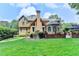 Gorgeous home exterior with brick accents, manicured lawn, and outdoor patio space at 10195 Brier Mill Ct, Alpharetta, GA 30022