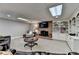 Cozy finished basement with a brick fireplace, built-in shelving, and comfortable seating at 10195 Brier Mill Ct, Alpharetta, GA 30022