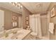 Bathroom with wallpaper, a sink, toilet, and shower with white tile at 10195 Brier Mill Ct, Alpharetta, GA 30022