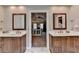 Beautiful bathroom featuring dual vanities, white marble floors, and views to the bedroom and walk-in closet at 10195 Brier Mill Ct, Alpharetta, GA 30022