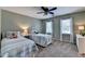 Cozy bedroom with two twin beds, neutral carpet, a ceiling fan, and bright natural light at 10195 Brier Mill Ct, Alpharetta, GA 30022