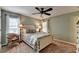 Comfortable bedroom with a ceiling fan, large window, and a cozy chair at 10195 Brier Mill Ct, Alpharetta, GA 30022