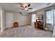 Spacious bedroom with carpet, ceiling fan, natural light, and a desk area with sewing machine at 10195 Brier Mill Ct, Alpharetta, GA 30022