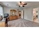 Spacious bedroom with carpet, ceiling fan, natural light, and a dresser with mirror at 10195 Brier Mill Ct, Alpharetta, GA 30022