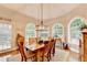 Charming dining area features a wooden table, large windows, and a cozy ambiance for Gathering gatherings at 10195 Brier Mill Ct, Alpharetta, GA 30022