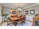Traditional dining room with wainscoting, chandelier, and ample seating for entertaining at 10195 Brier Mill Ct, Alpharetta, GA 30022
