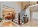 Elegant foyer with staircase, hardwood floors, and views into the formal dining room at 10195 Brier Mill Ct, Alpharetta, GA 30022