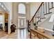 Grand foyer with soaring ceilings, hardwood floors, and staircase with decorative railing at 10195 Brier Mill Ct, Alpharetta, GA 30022