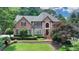 Stately brick home with manicured lawn and mature landscaping offering classic curb appeal at 10195 Brier Mill Ct, Alpharetta, GA 30022