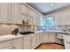 Contemporary kitchen features ample counter space, modern appliances, and a stylish gray backsplash for a sleek and modern look at 10195 Brier Mill Ct, Alpharetta, GA 30022