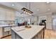 Open concept kitchen with a large island, stainless steel appliances, and seamless flow to an adjacent living space at 10195 Brier Mill Ct, Alpharetta, GA 30022