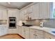 Modern kitchen with sleek white cabinets, stainless steel appliances, and stylish backsplash for a contemporary feel at 10195 Brier Mill Ct, Alpharetta, GA 30022