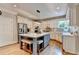 Stylish kitchen boasts a central island with seating, stainless steel appliances, and elegant white cabinetry for ample storage at 10195 Brier Mill Ct, Alpharetta, GA 30022