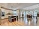 Bright kitchen with a large island, white cabinets, stainless steel appliances, and an adjacent breakfast area with arched windows at 10195 Brier Mill Ct, Alpharetta, GA 30022