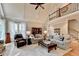 Inviting living room with high ceilings, plush seating, neutral decor, and staircase leading to a second-story loft area at 10195 Brier Mill Ct, Alpharetta, GA 30022