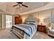 Comfortable main bedroom boasting a tray ceiling, carpet, and neutral-colored walls at 10195 Brier Mill Ct, Alpharetta, GA 30022