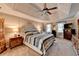 Spacious main bedroom featuring a tray ceiling, carpet, and neutral tones at 10195 Brier Mill Ct, Alpharetta, GA 30022