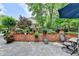 Outdoor patio with stone pavers, a dining set under an umbrella, and backyard at 10195 Brier Mill Ct, Alpharetta, GA 30022