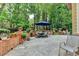 Outdoor patio with stone pavers, a dining set under an umbrella, and garden views at 10195 Brier Mill Ct, Alpharetta, GA 30022