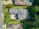 Aerial shot of a home with well-manicured landscaping, driveway, and nearby pool at 1382 Murrays Loch Nw Pl, Kennesaw, GA 30152