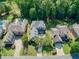 An aerial view of a home showcasing its landscaped yard, pool, and surrounding neighborhood at 1382 Murrays Loch Nw Pl, Kennesaw, GA 30152