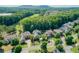 Scenic aerial view of homes in a lush, green neighborhood with mature trees and a golf course backdrop at 1382 Murrays Loch Nw Pl, Kennesaw, GA 30152