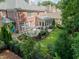 Serene backyard view featuring brick home, stone patio with pergola, and beautifully landscaped garden at 1382 Murrays Loch Nw Pl, Kennesaw, GA 30152