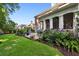 Exterior view showcases a patio, manicured lawn, garden beds with flowers and plants, and a red brick home at 1382 Murrays Loch Nw Pl, Kennesaw, GA 30152