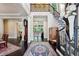 Grand foyer featuring dark hardwood floors, staircase, and elegant decor with views to living areas at 1382 Murrays Loch Nw Pl, Kennesaw, GA 30152