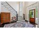Elegant foyer with hardwood floors, staircase, and natural light from the glass paneled front door at 1382 Murrays Loch Nw Pl, Kennesaw, GA 30152